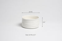 White ceramic bowl with dimensions on a light gray background