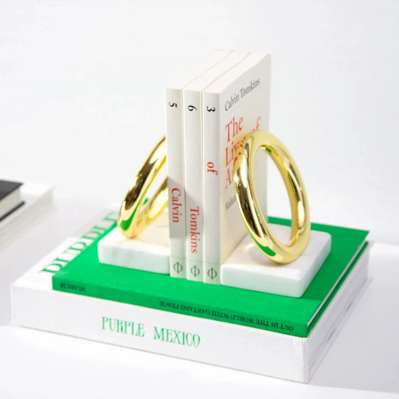 Marble bookends with gold rings.