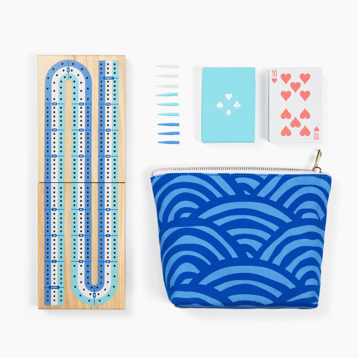 Cribbage board with blue pattern, pouch, cards, and tiles on a white background