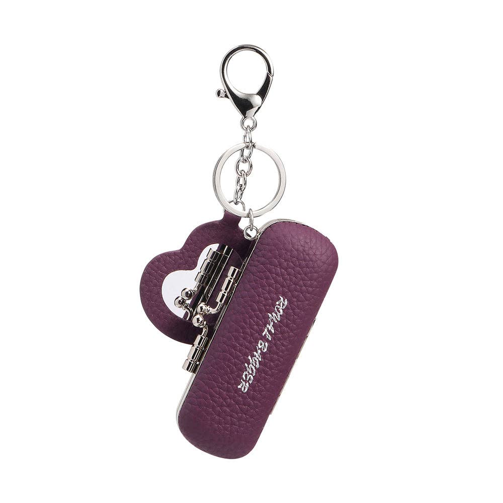 A purple textured leather keychain case with a heart-shaped charm and silver-tone metal hardware, shown on a plain white background.
