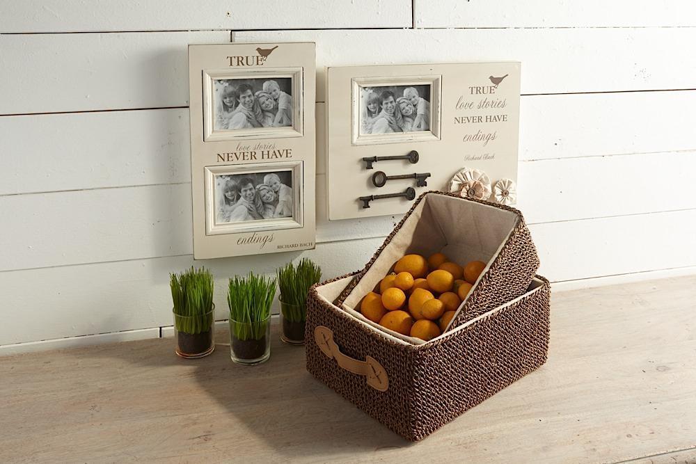 Woven basket with lemons on a wooden floor, framed photos in the background.
