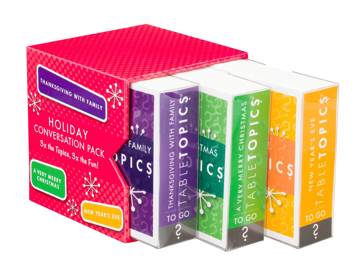 A boxed holiday conversation pack labeled 'Holiday Conversation Pack' with a bright pink outer box and four colorful inner boxes showing the topics: Family, Thanksgiving with Family, To Go, and New Year's Eve. The product is photographed on a clean white background.