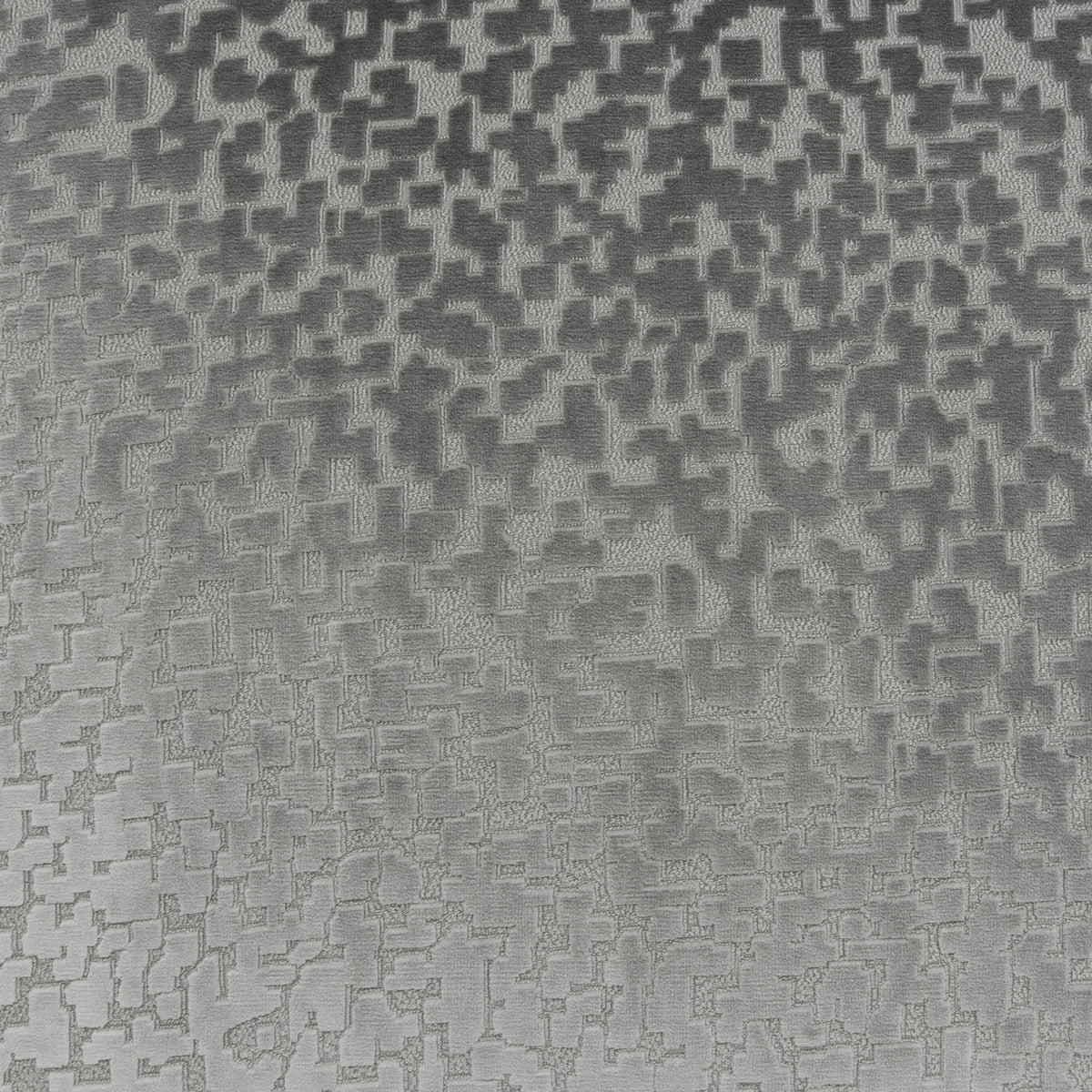 A close-up of a gray and silver textured material with a repeating geometric pixelated pattern.
