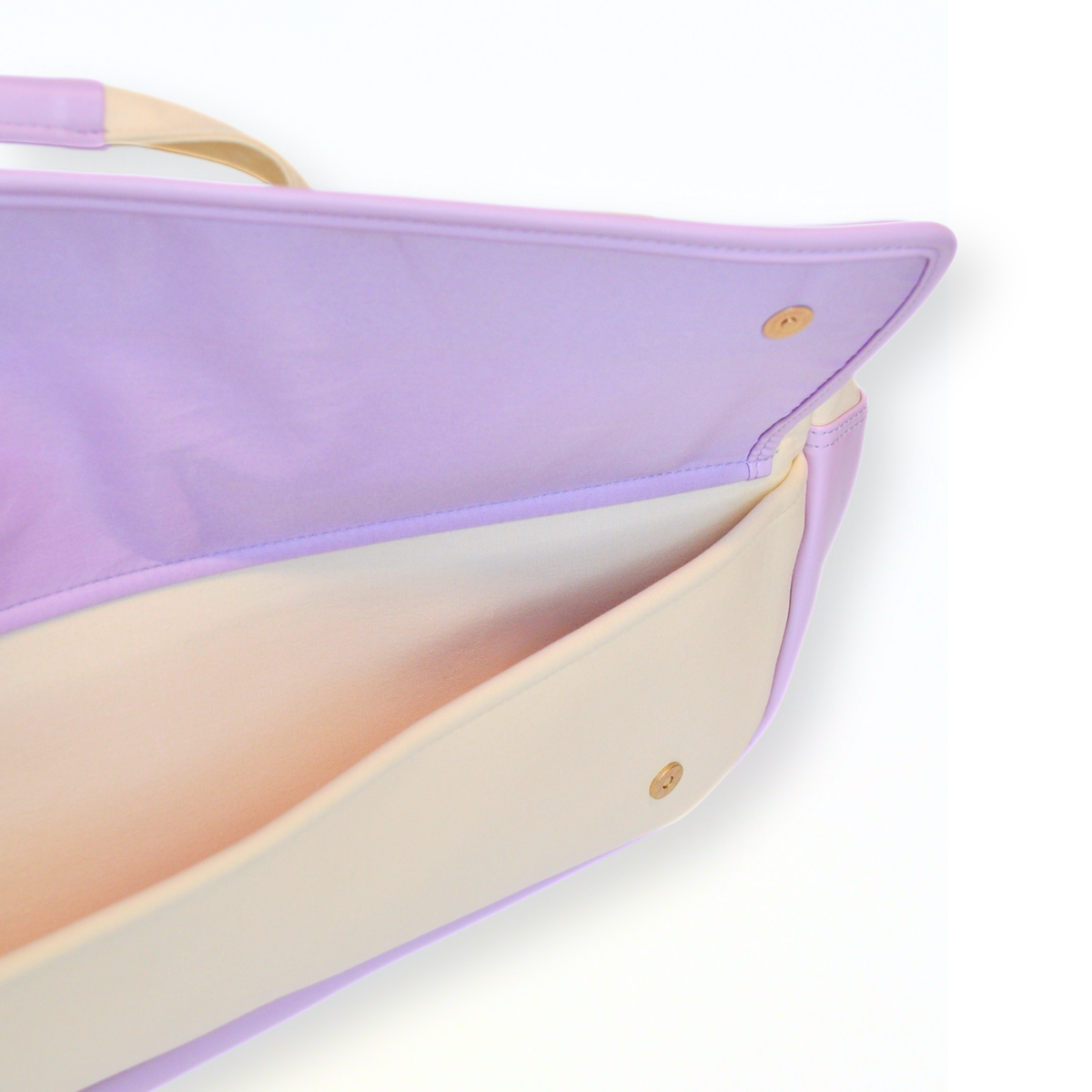 Close-up of a purple and beige handbag on a white background