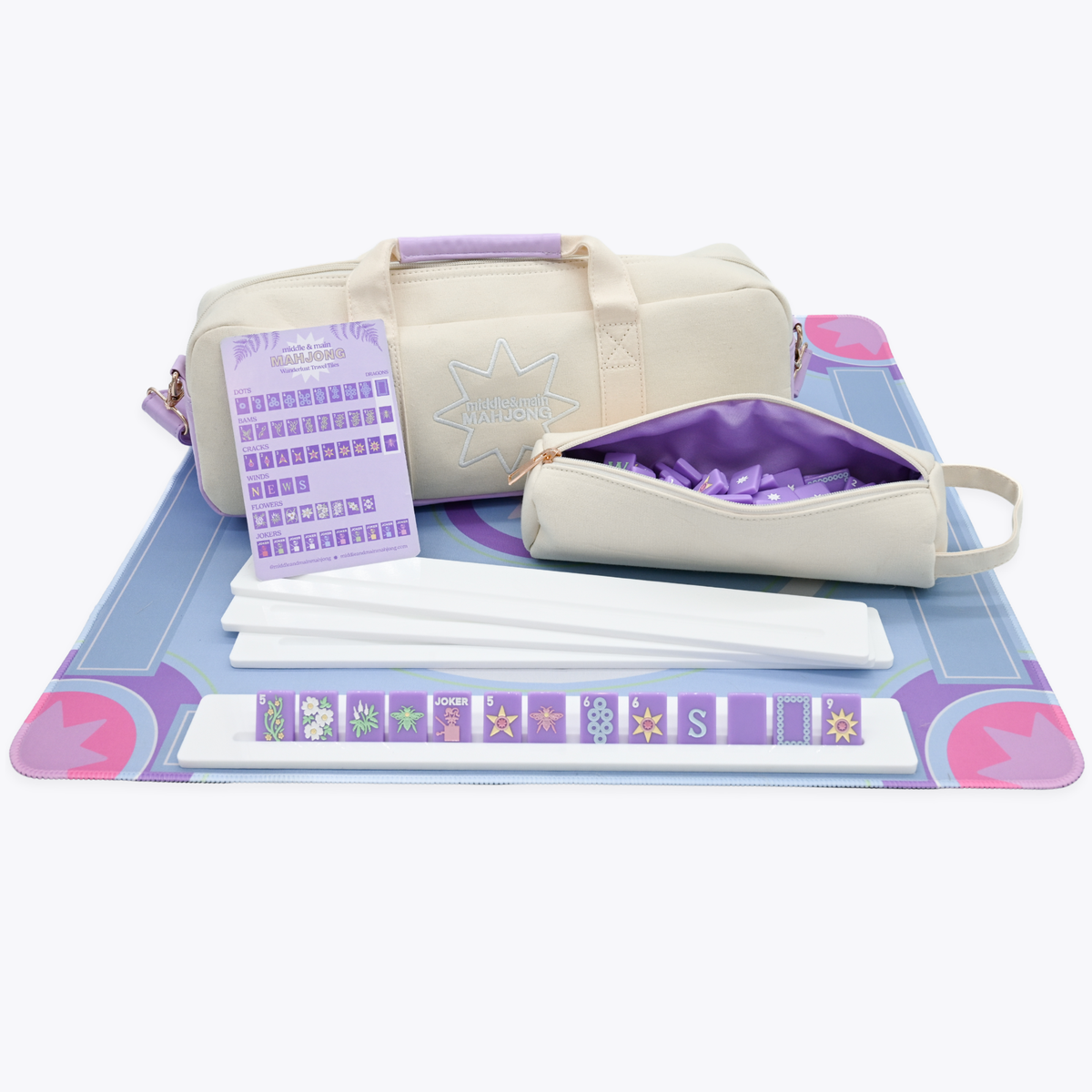 Set of bags and mahjong accessories on a mat with a white background