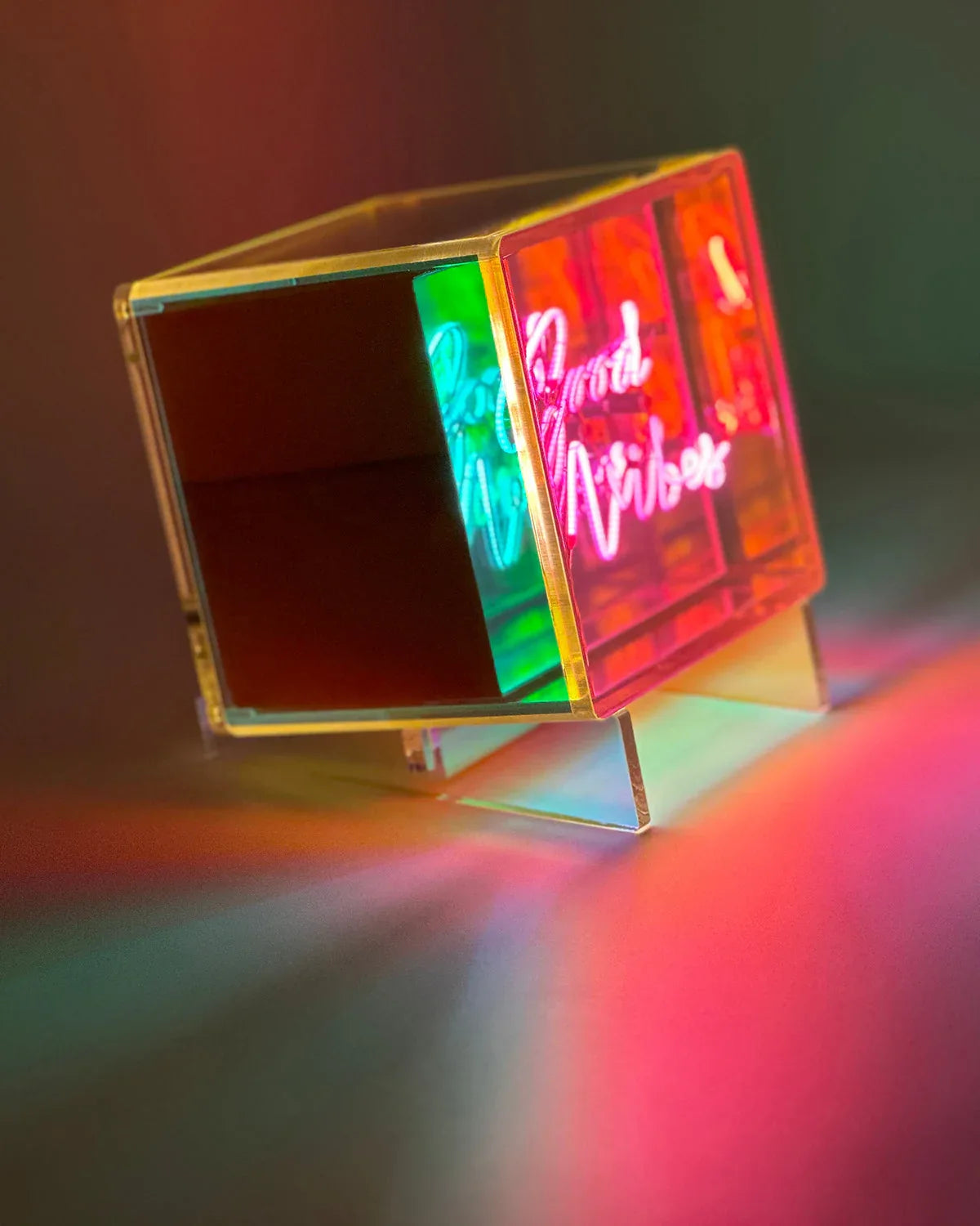 Neon sign with colorful gradient on a dark background