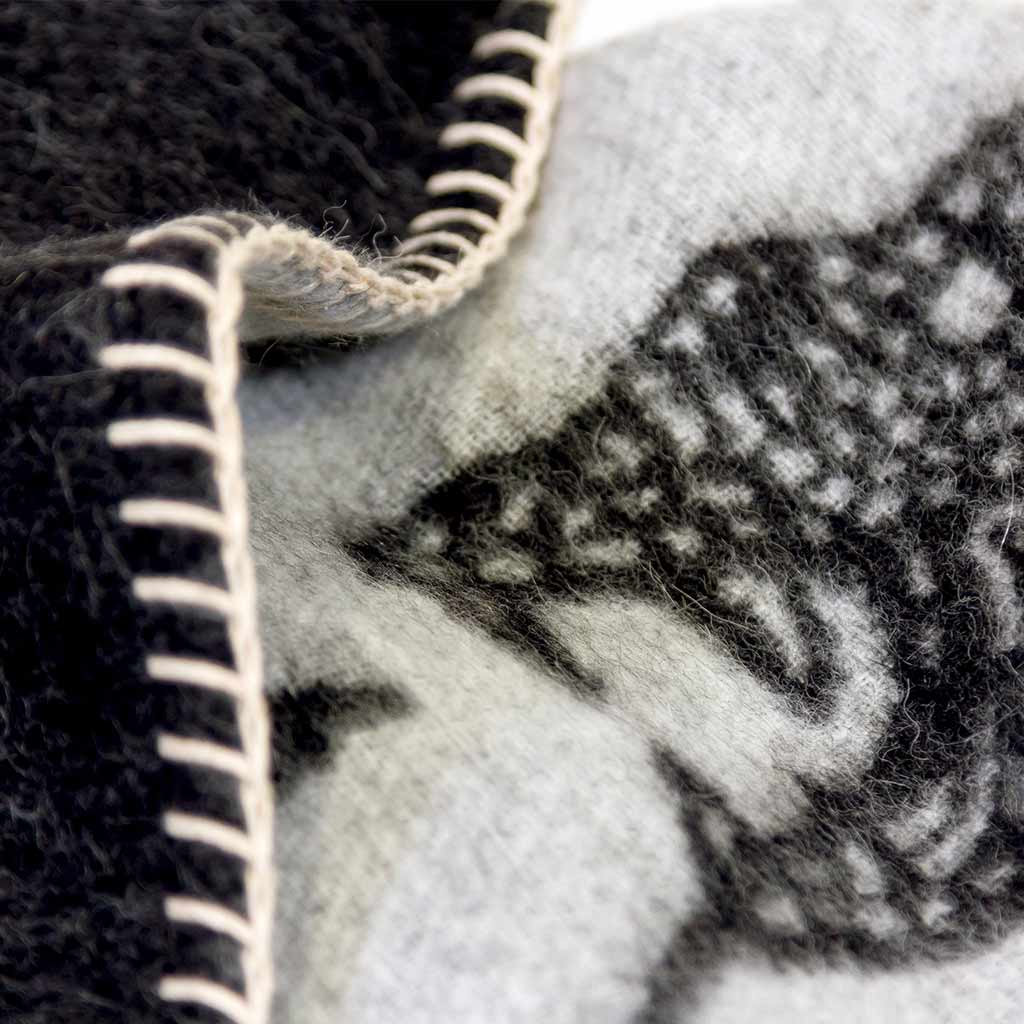 Peyote Rattlesnake Grey/Dark Grey throw with ivory stitching. 