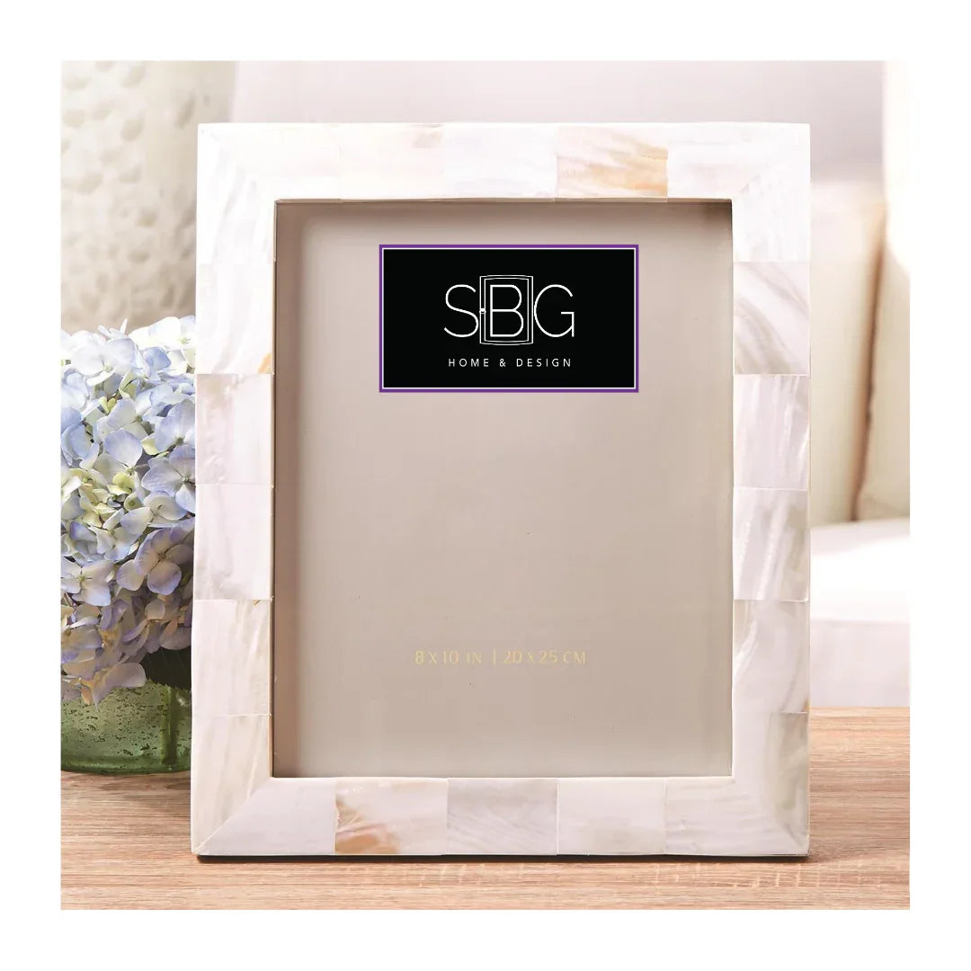 Decorative picture frame with SBG Home & Design logo on a light background