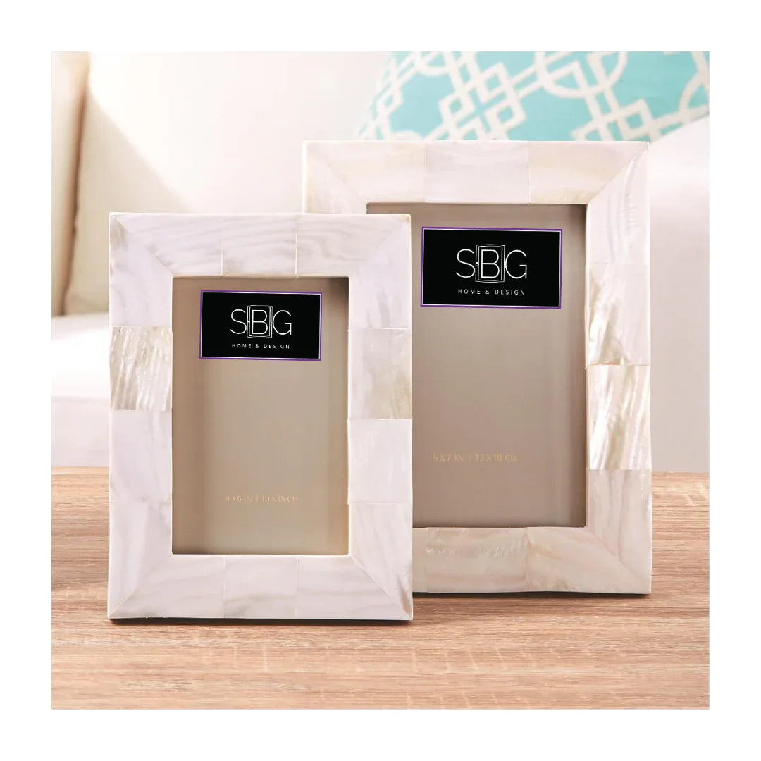 Two marble picture frames with SBG logo on a wooden surface.