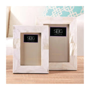 Two marble picture frames with SBG logo on a wooden surface.