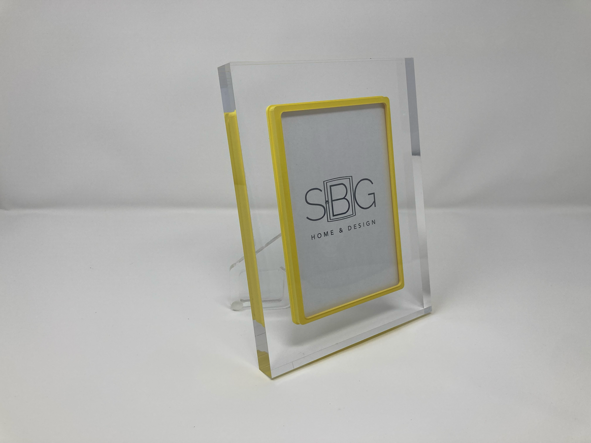 Clear acrylic photo frame with yellow border on a white background SBG Home and Design