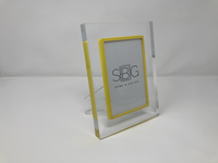 Clear acrylic photo frame with yellow border on a white background SBG Home and Design