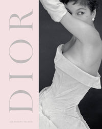 Book cover of 'Dior' by Alexandra Palmer with a model in a white dress on a pink background.