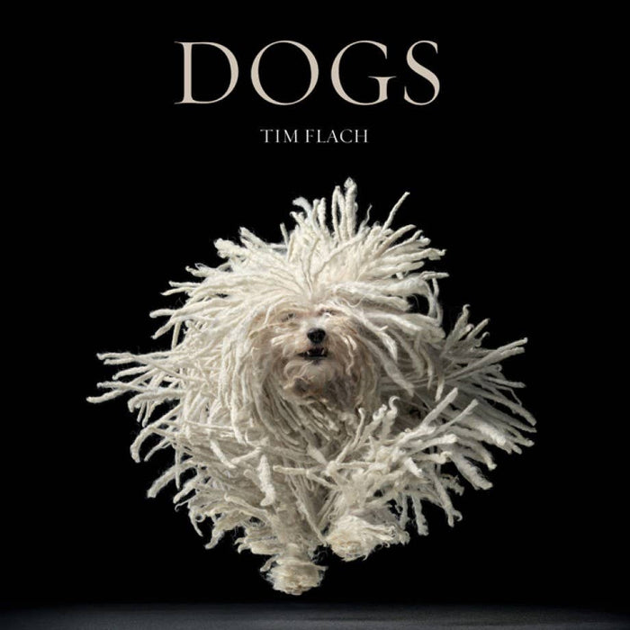 Book cover of 'DOGS' by Tim Flach featuring a dog with a textured coat fur on a black background.