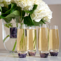 Champagne glasses with amethyst features.