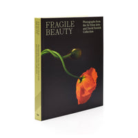 Book titled 'Fragile Beauty' with a poppy flower on the cover