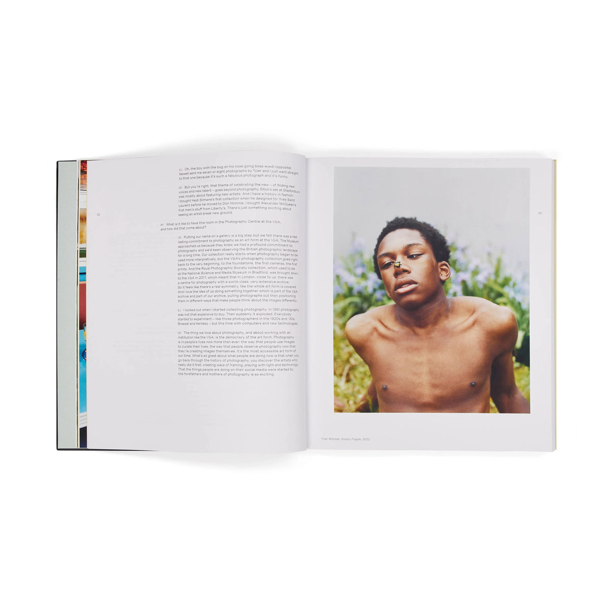 Open book showing a page with text and an image of a shirtless person outdoors.