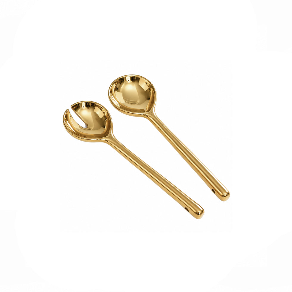 Two gold-colored metal serving spoons with a polished finish, displayed on a clean white background.