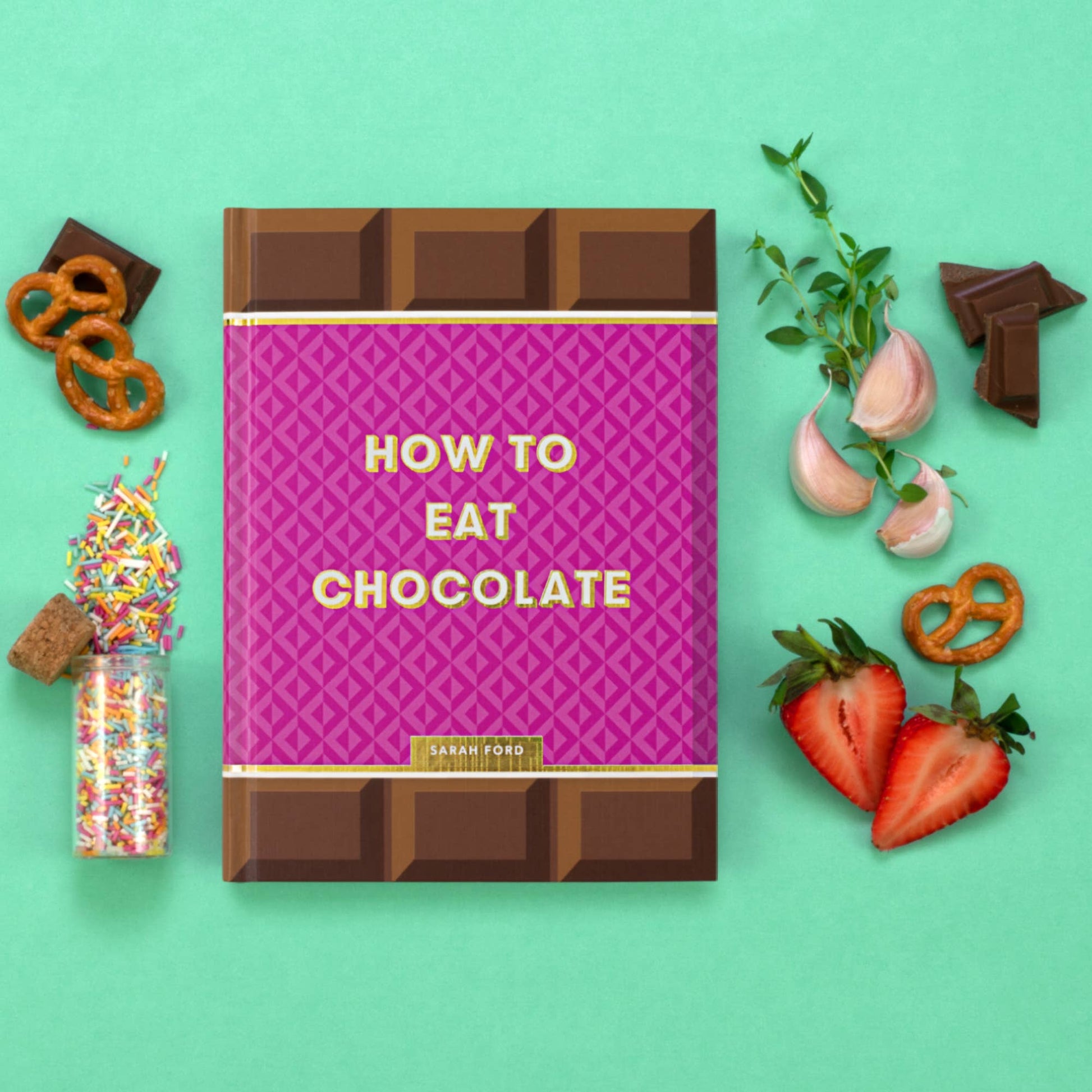 Book titled 'How to Eat Chocolate' with chocolate-themed decorations on a green background