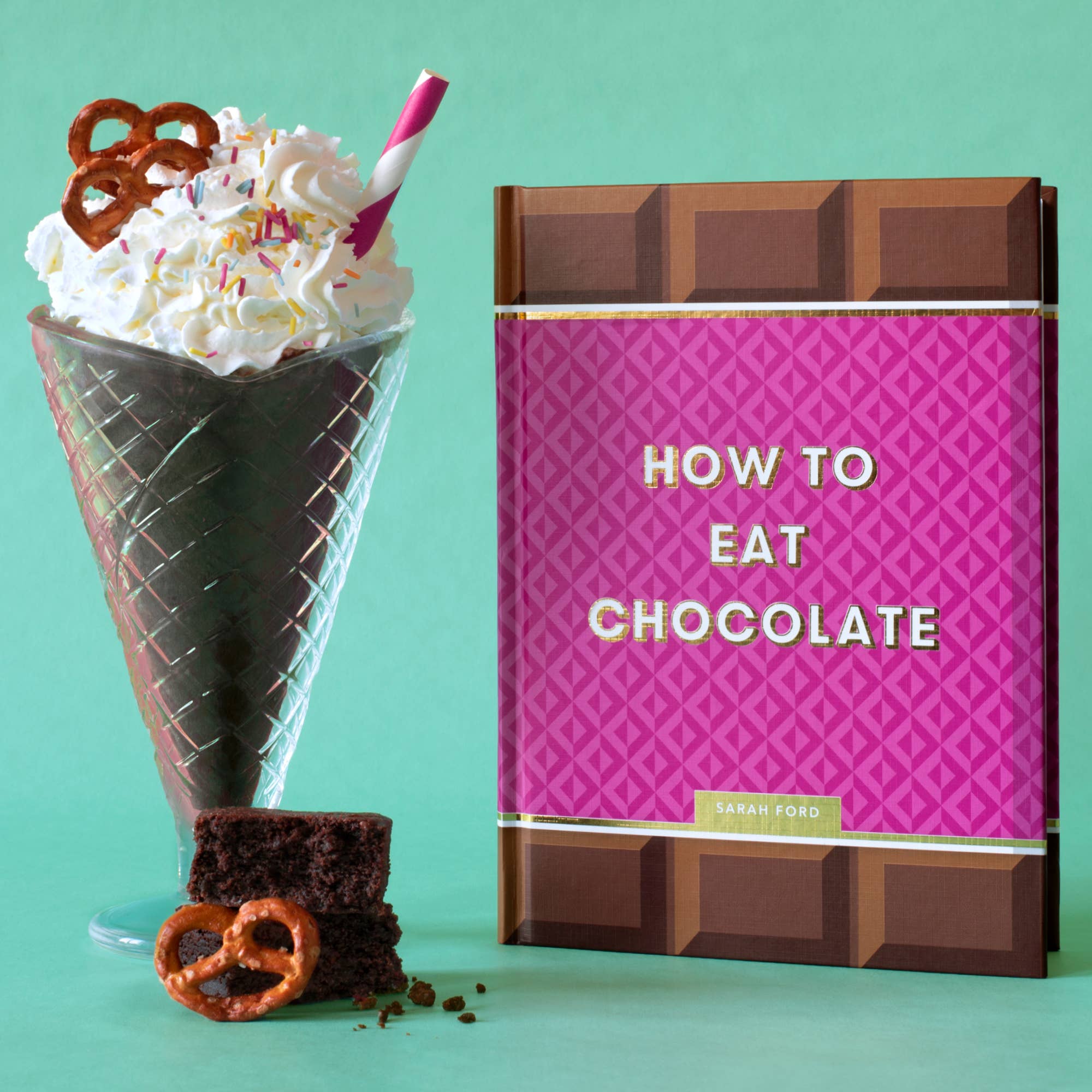 Book titled 'How to Eat Chocolate' with a chocolate-themed ice cream cone and pretzels on a green background
