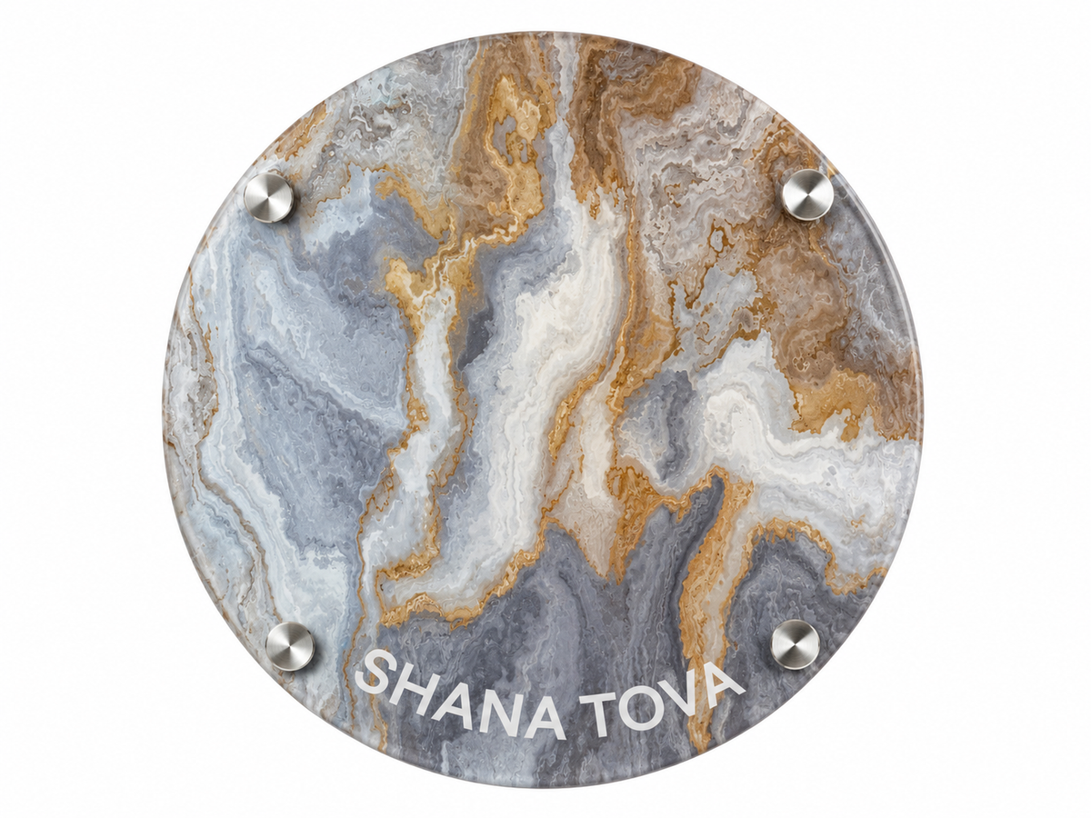 A round personalized marble coaster with a gray, white, and gold agate-like pattern, featuring the name 'SHANA TOVA' printed in white at the bottom and secured with four silver metal studs.