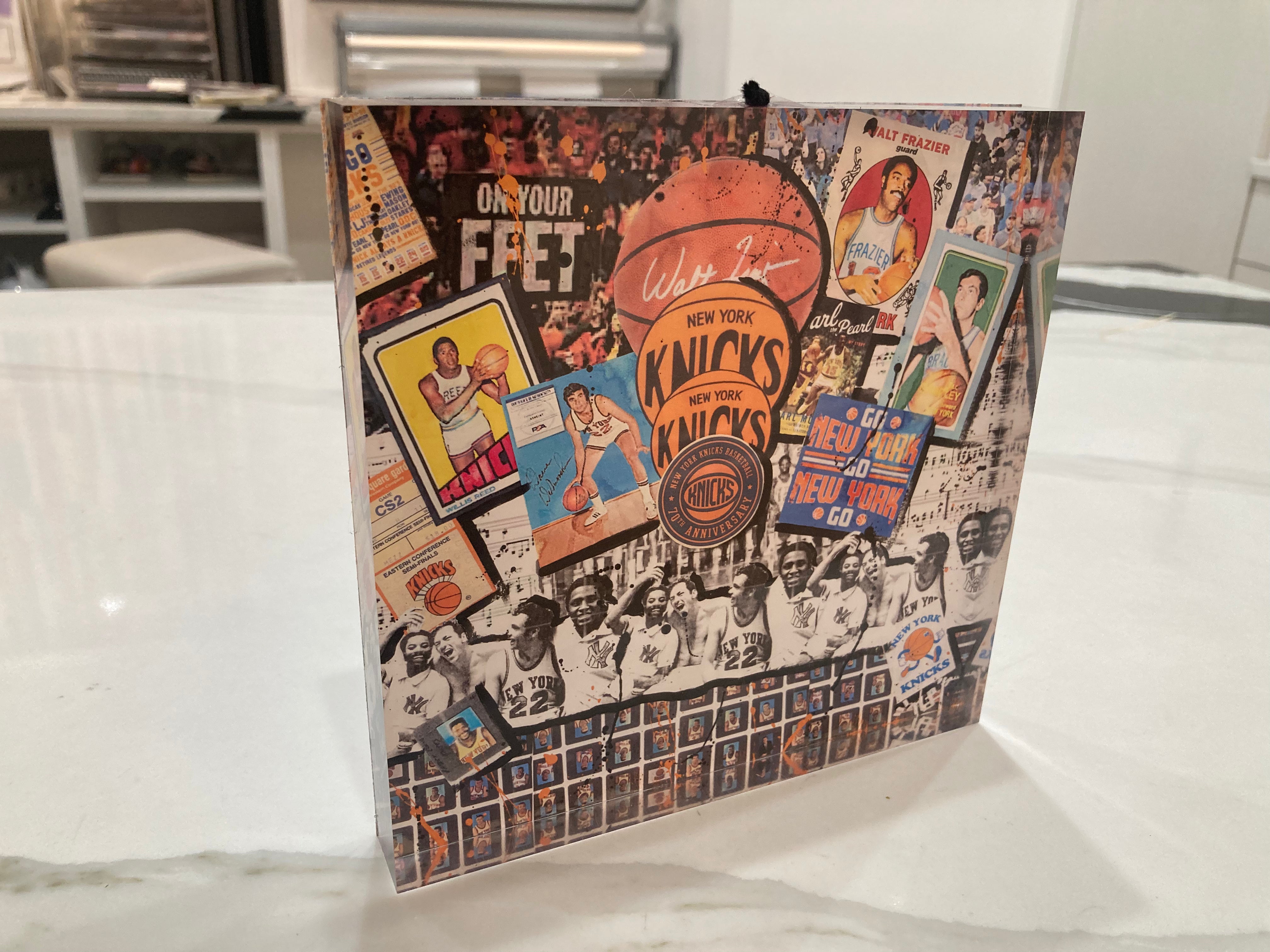 Collage of vintage New York Knicks basketball memorabilia on a surface.