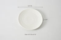 White ceramic plate with dimensions on a gray background