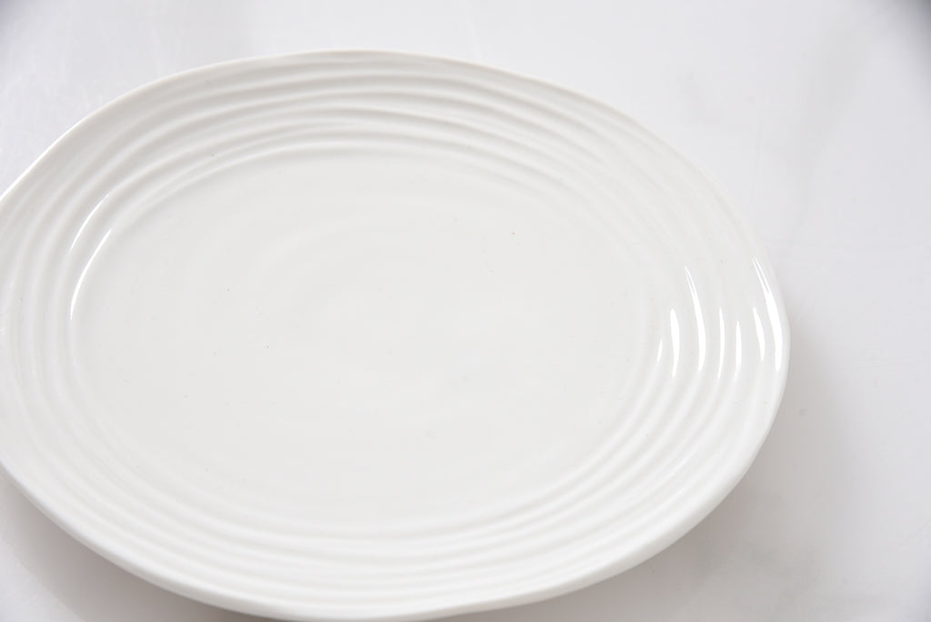 White ceramic plate on a white background