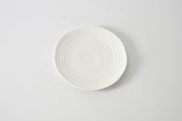 White ceramic plate on a light gray background