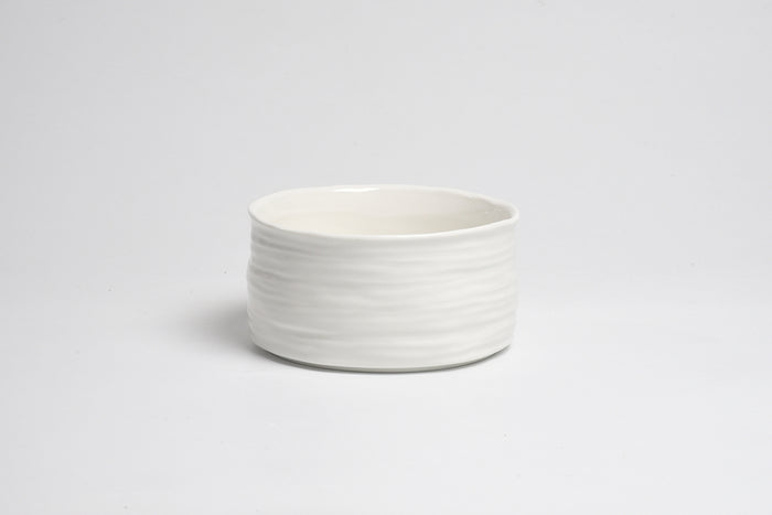 White ceramic bowl on a light gray background