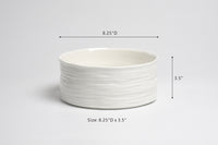 White ceramic bowl with dimensions on a light gray background