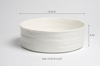 White ceramic bowl with dimensions labeled on a gray background
