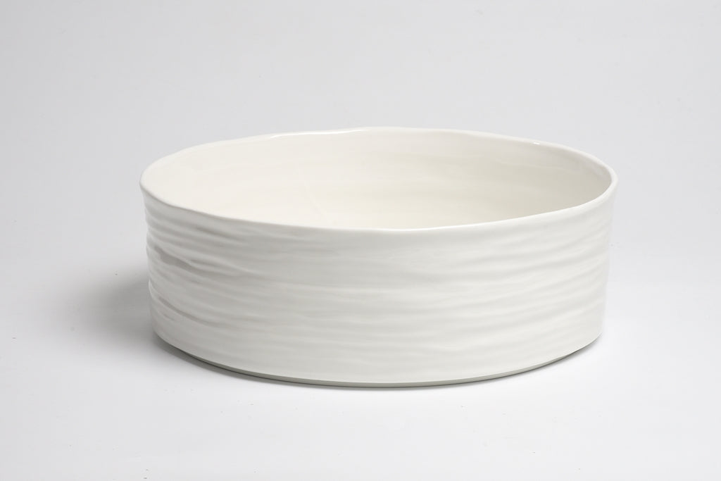 White ceramic bowl on a light gray background