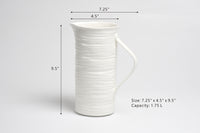 White ceramic pitcher with dimensions and capacity details on a gray background