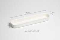 White ceramic tray with dimensions on a light gray background