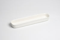 White ceramic tray on a light gray background