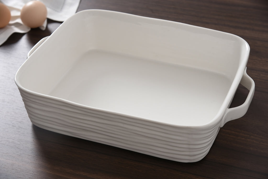 White ceramic baking dish on a wooden surface