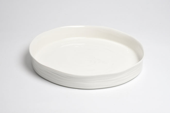 White ceramic plate on a light gray background