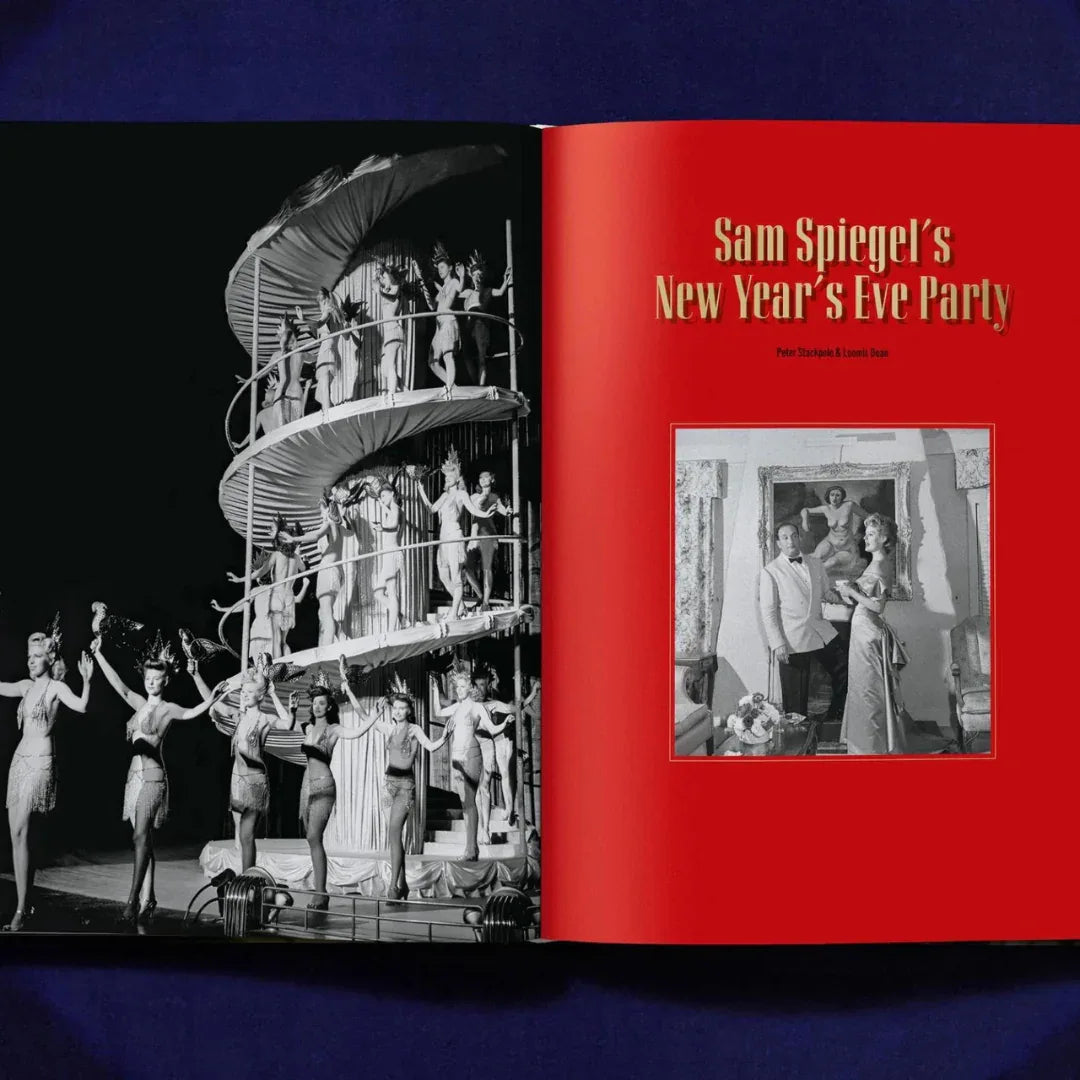Book open to a page with a black and white photo of a New Year's Eve party on stage and a red cover with text.