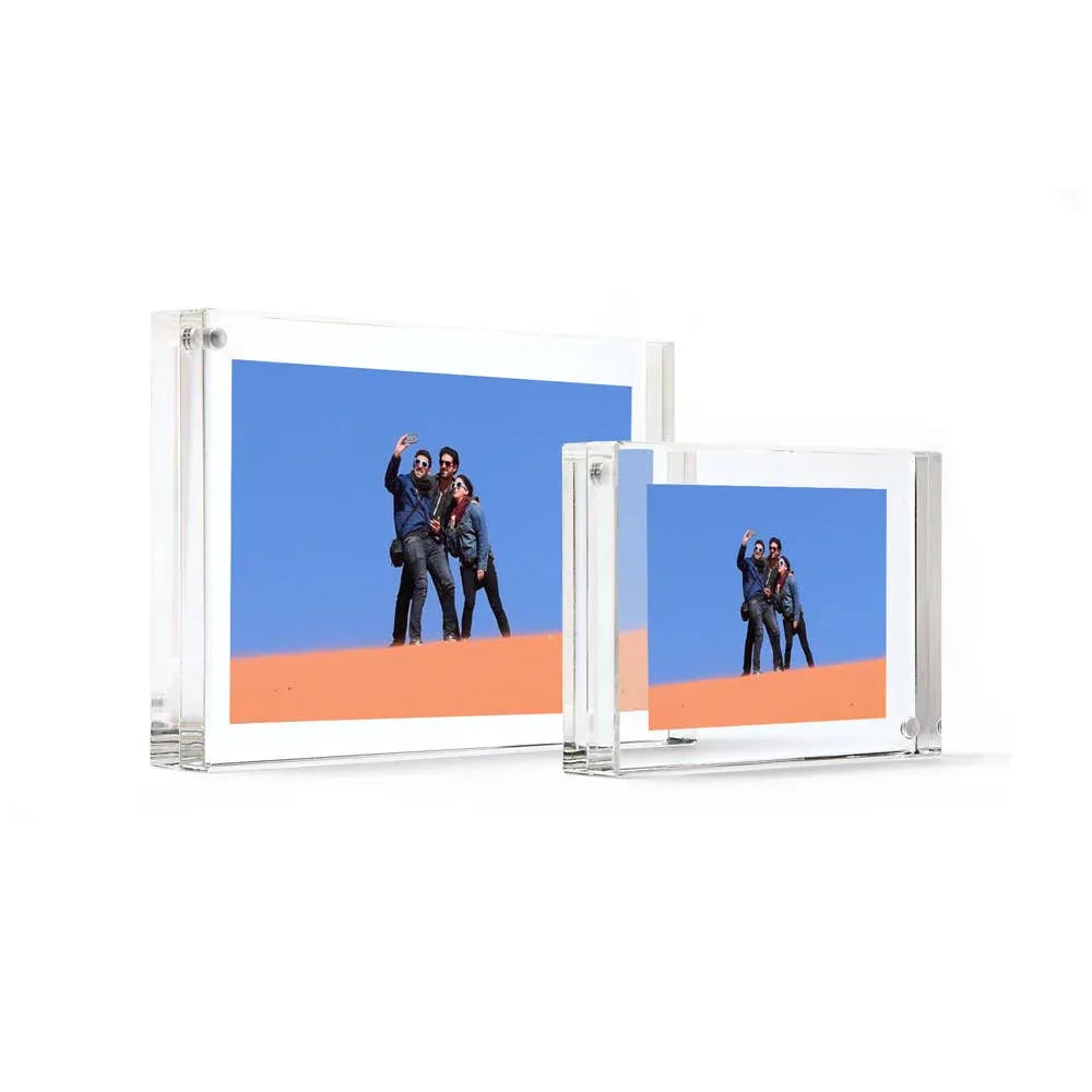 Two transparent acrylic photo frames displaying a photo of people on a desert background.
