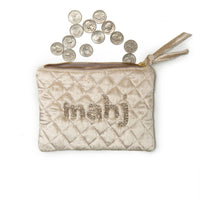 Quilted coin purse with 'mahj' text and coins on a white background
