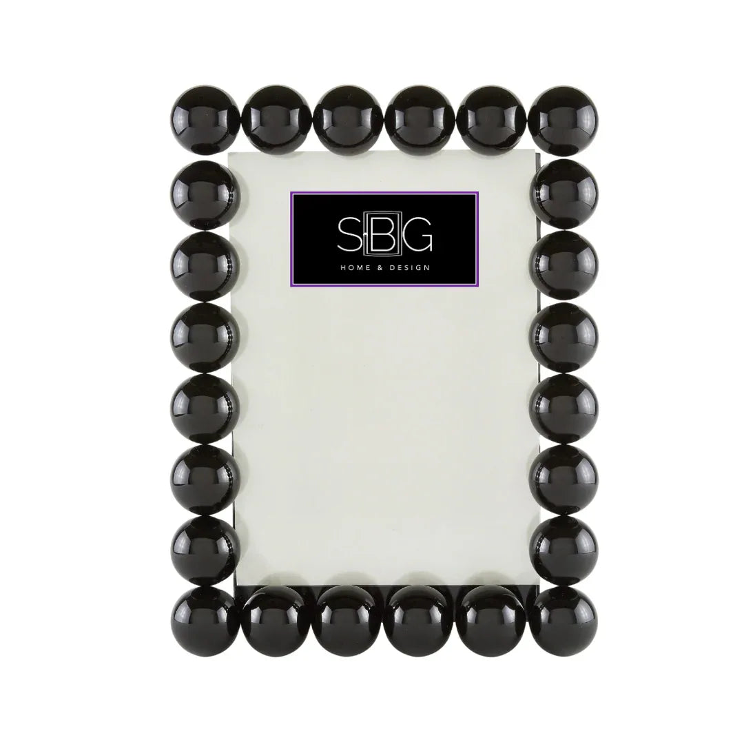 Black beaded frame with a white center on a white background, featuring the SBG logo.