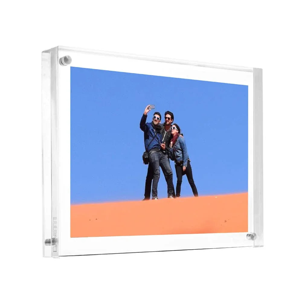 Acrylic photo frame with a scenic background of two people taking a selfie against a blue sky and orange landscape.