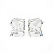 A pair of clear faceted crystal stud earrings shaped like stacked geometric cubes, shown on a plain white background.
