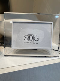 Clear acrylic Picture Frame with 'SBG Home & Design' logo on a surface