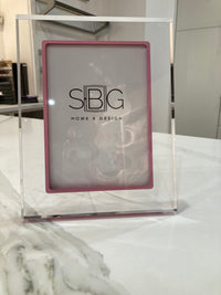 Haute Pink picture frame with SBG HOME & DESIGN logo on a marble surface