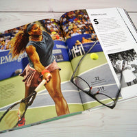 Open book featuring Serena Williams,  a tennis player on a sports magazine with glasses on top