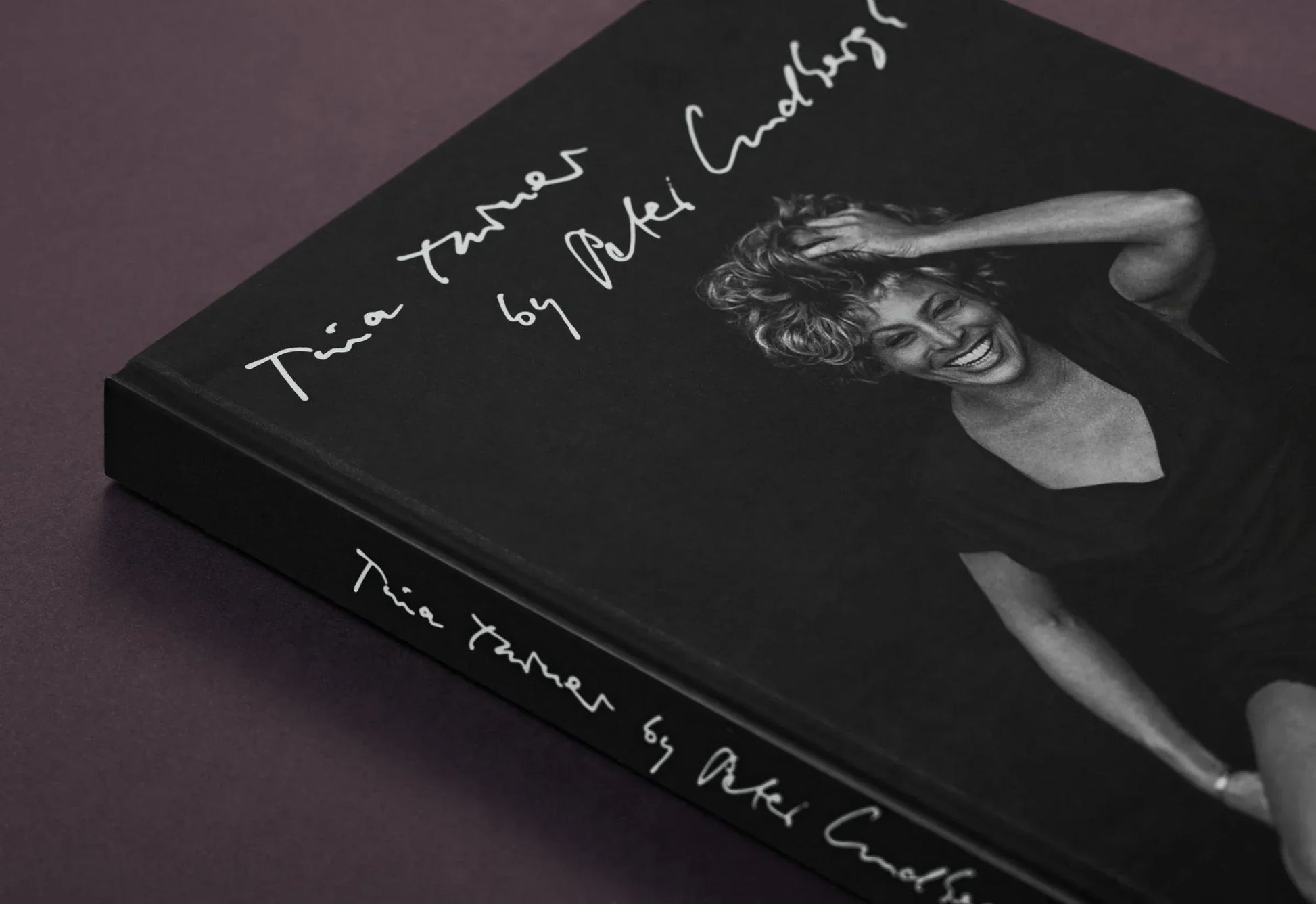 Book cover with a black and white portrait and cursive text on a dark background