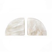 Two polished white stone semicircle bookends on a solid white background.