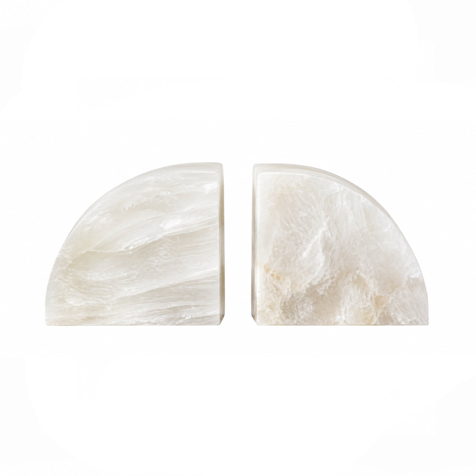 Two polished white stone semicircle bookends on a solid white background.